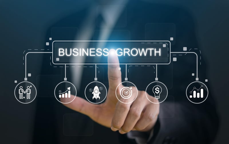 Finger pointing at a screen with the words Business Growth