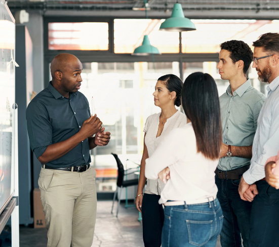 Salespeople standing for a team meeting