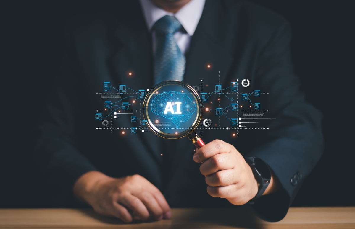 Magnifying glass being help my two hands showing AI