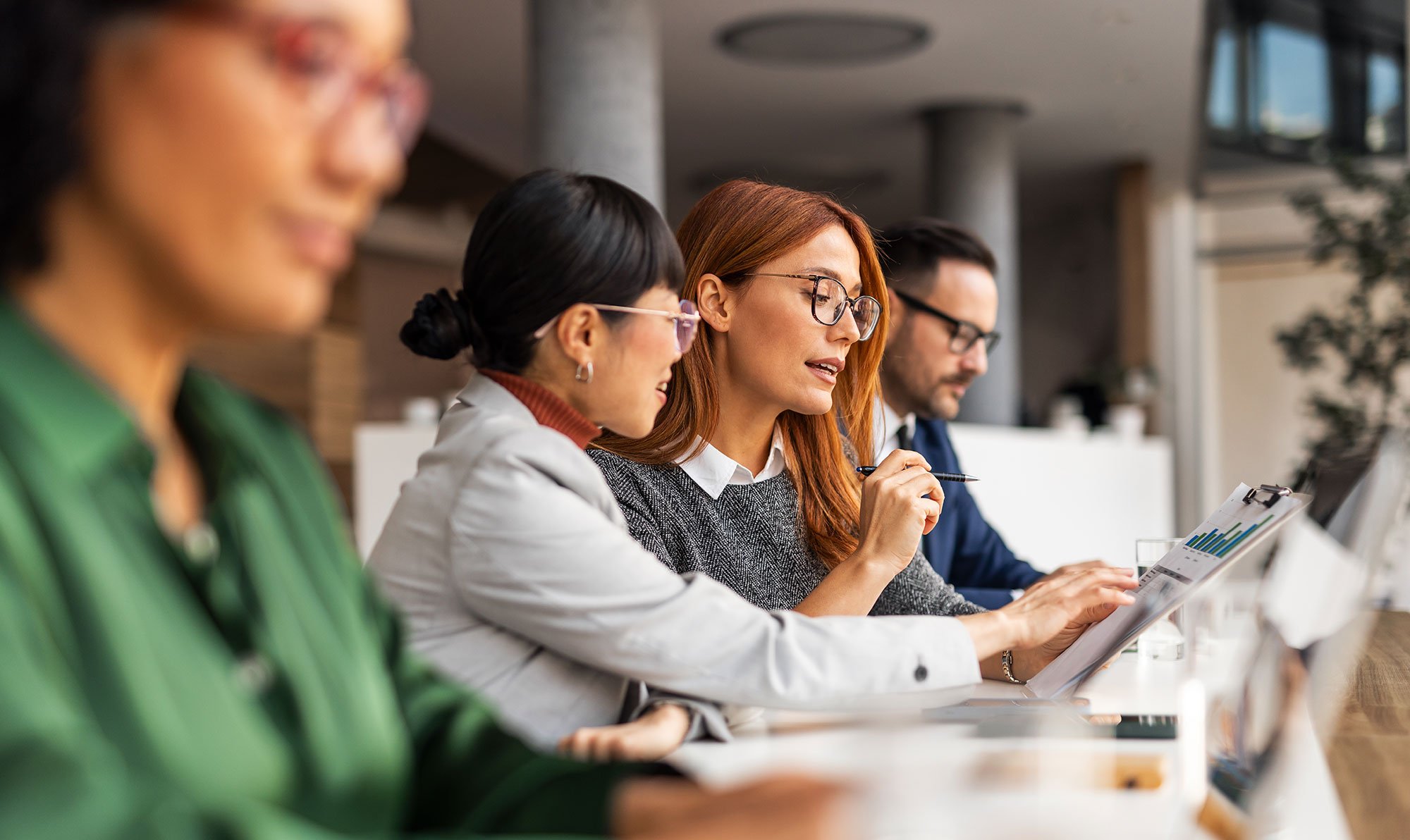 A team of professionals reviewing graphs and stategy