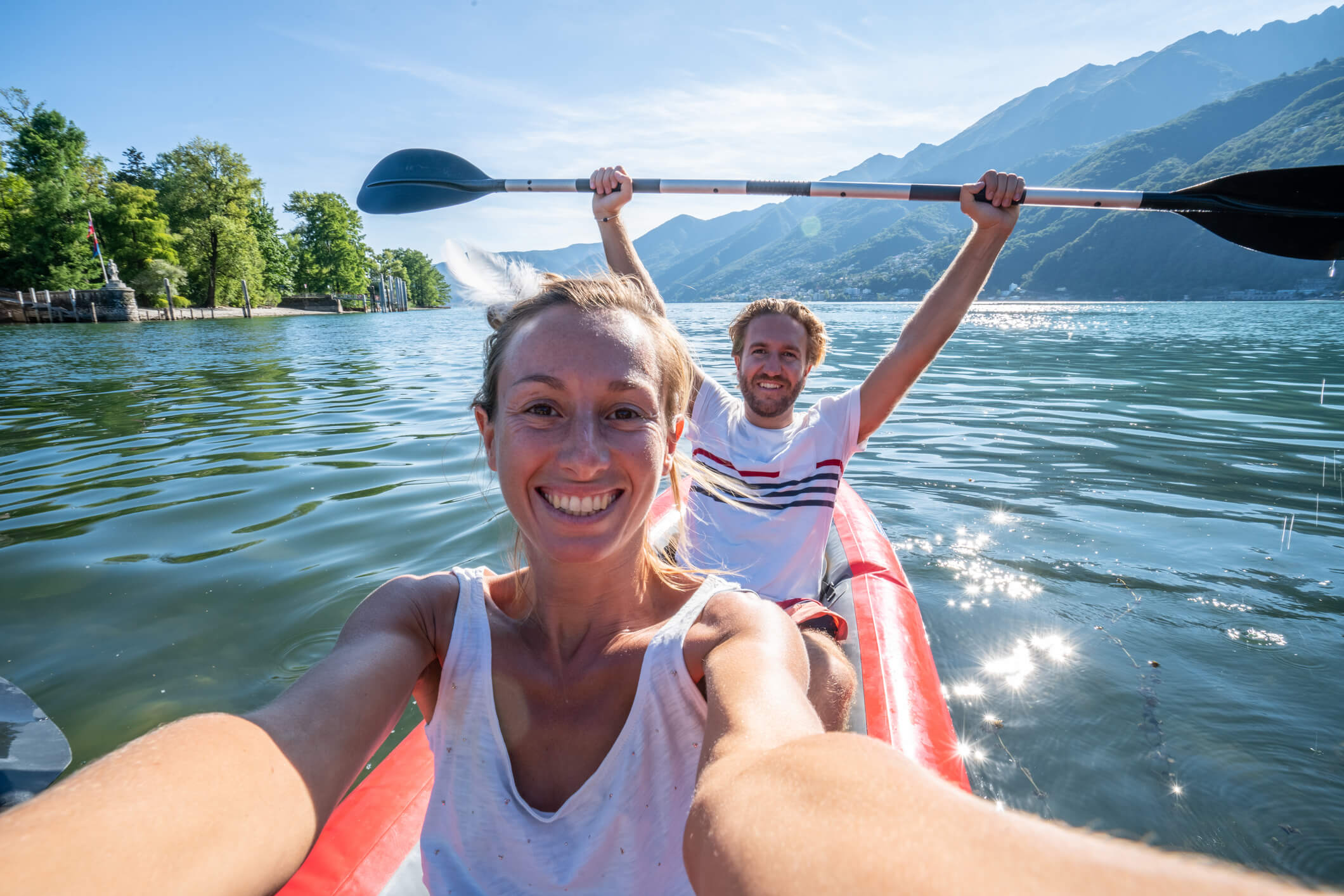 A man and women kayaking in a beautiful river