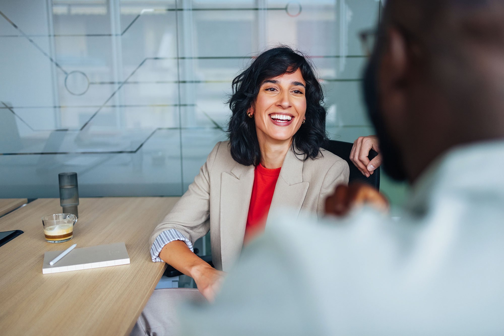 A man and a woman at a desk during an interview