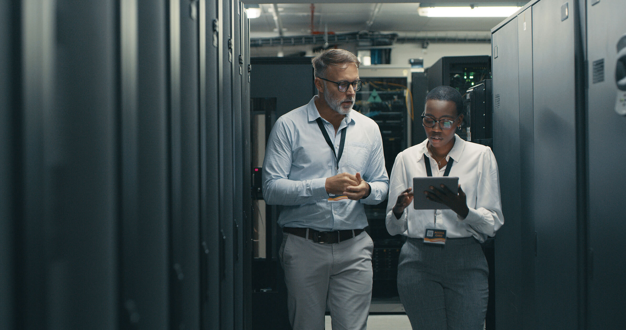Two people in a server room