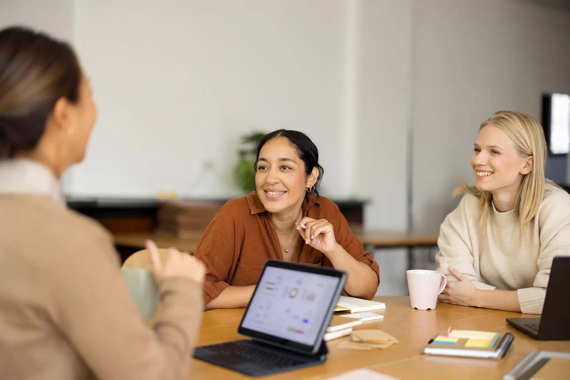 3 coworkers gathered around a table