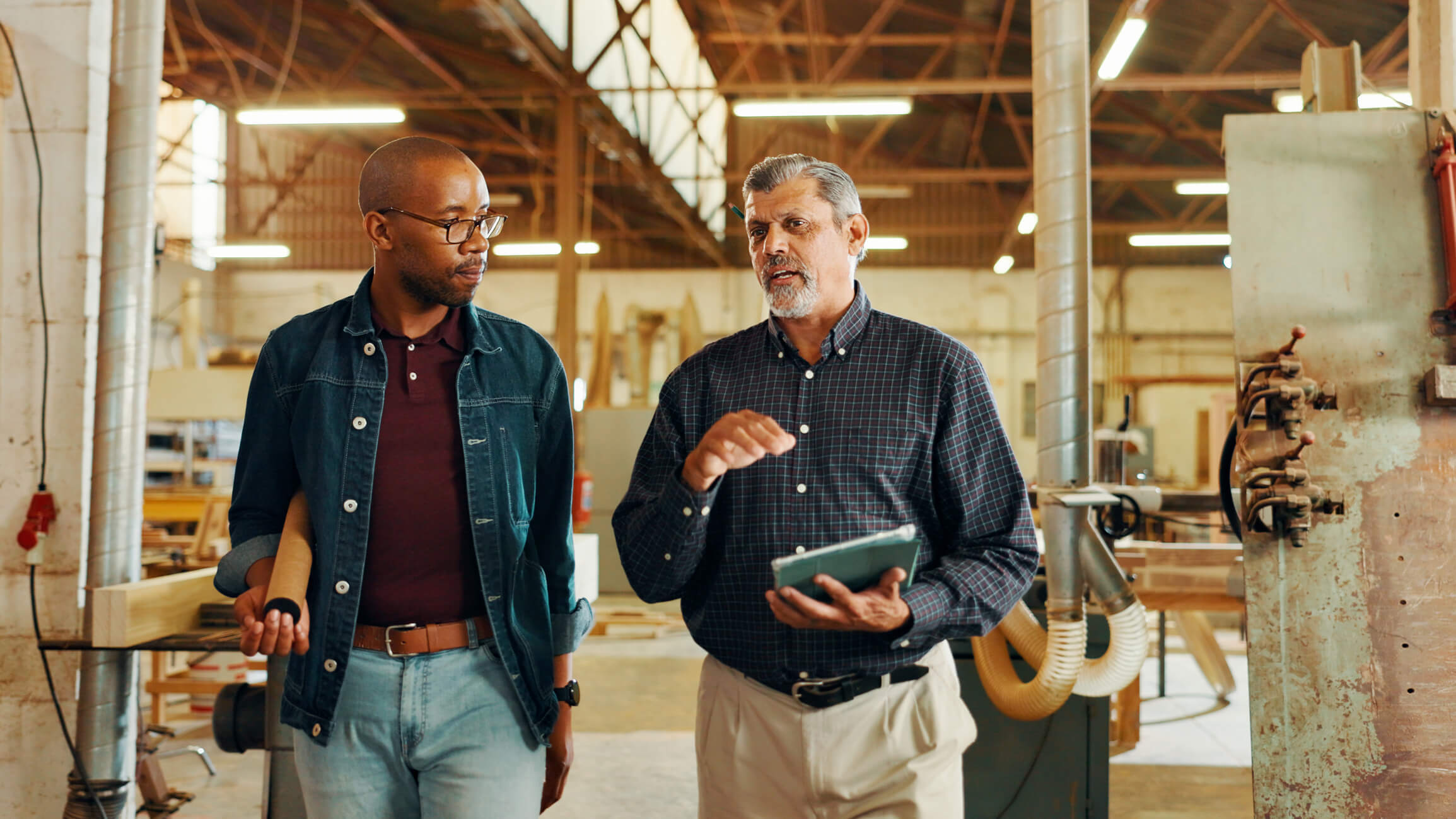 Two men walking through a construction site