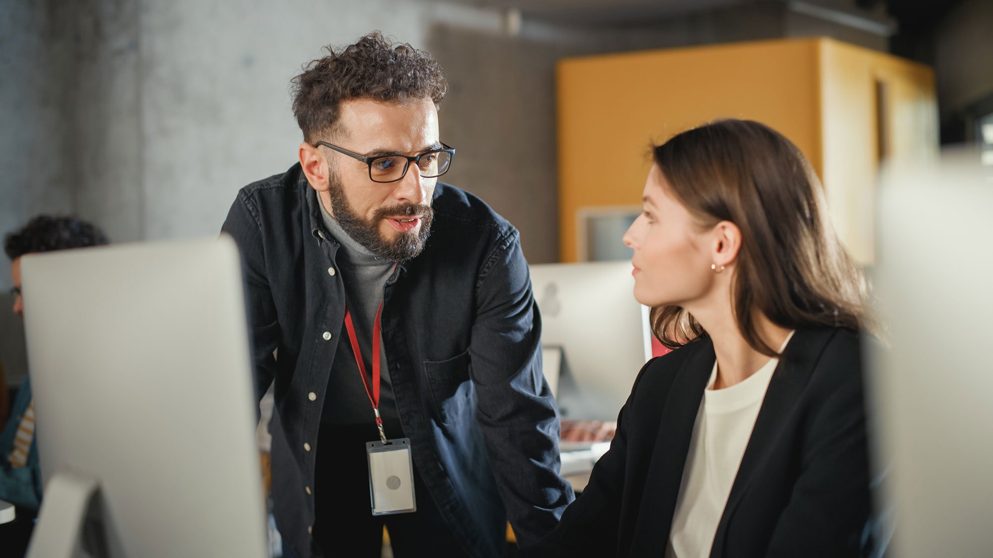Man and woman discuss business at an office