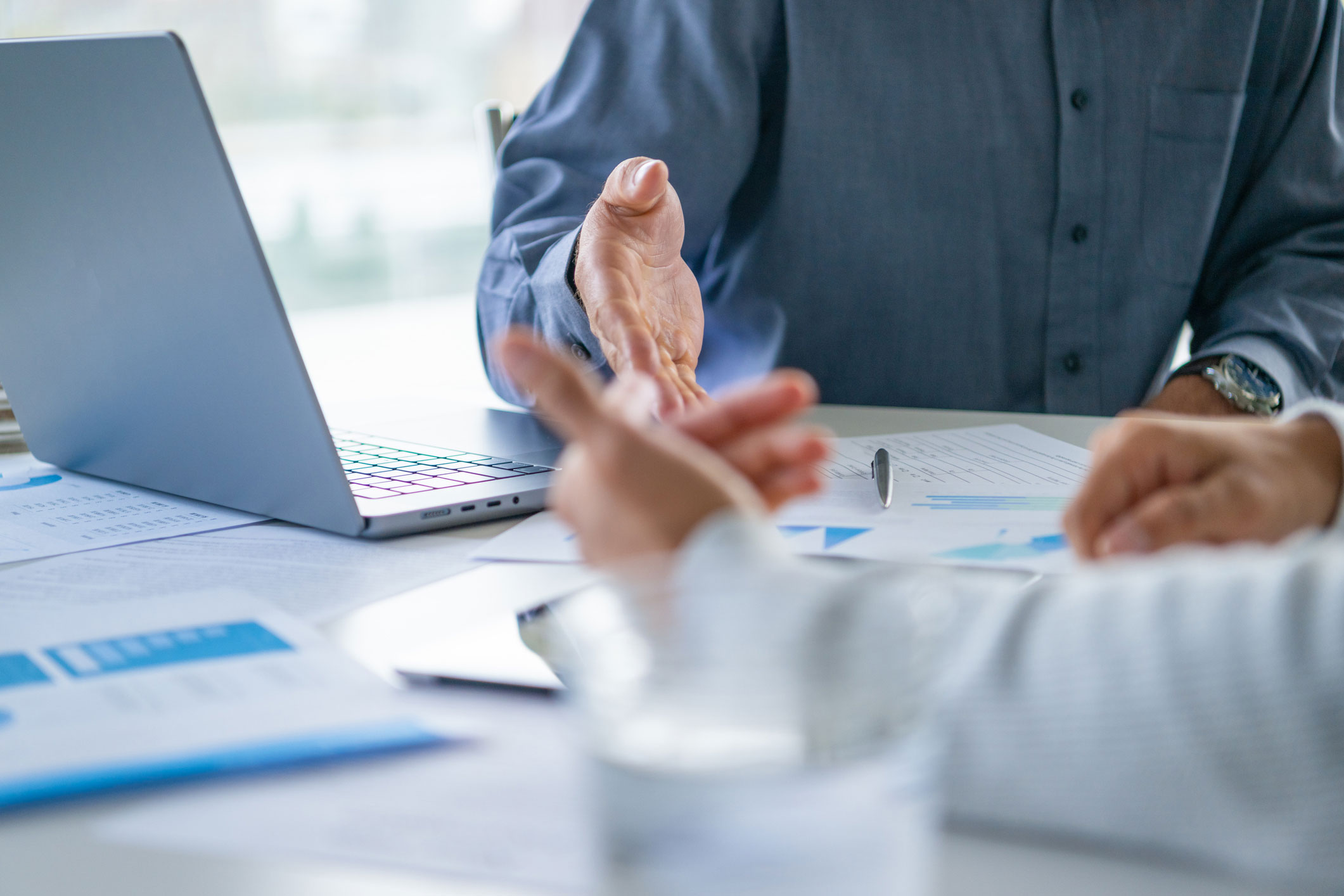 Closeup of two people at a desk