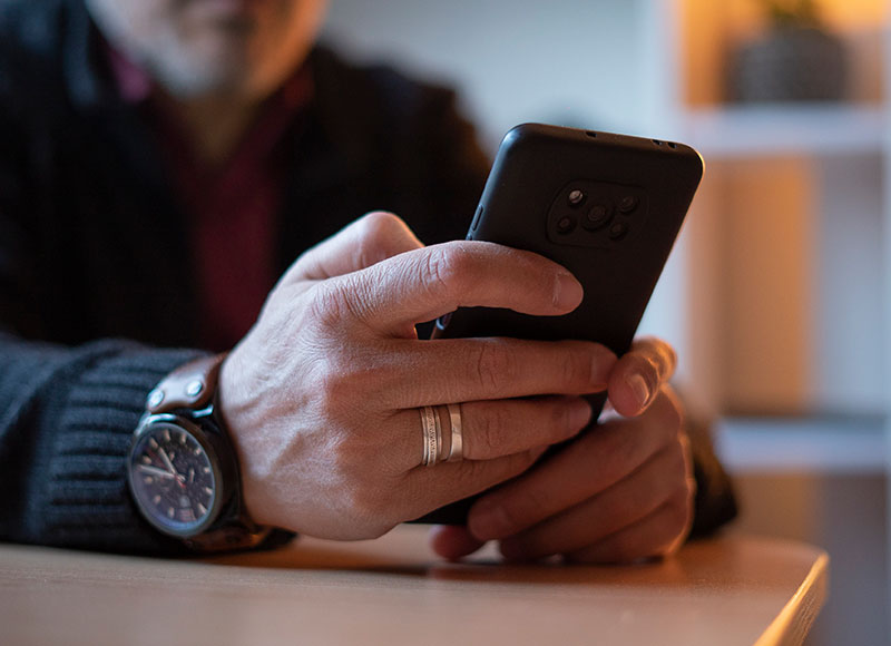 Closeup of a man's hands on a smartphone