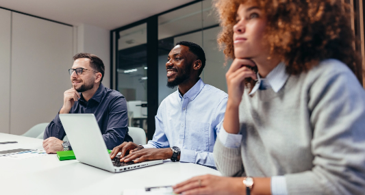 Three salespeople seated in a conference room