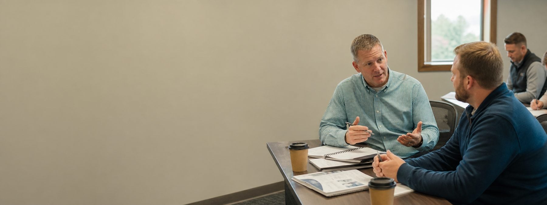 A sales coach asking questions during a training workshop