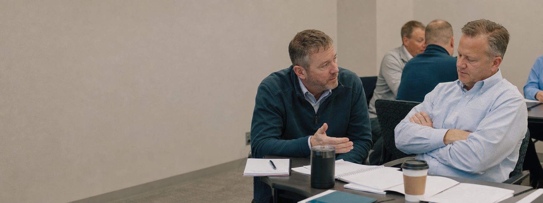 A salesperson calmly working through a buyer stall during a workshop role-play