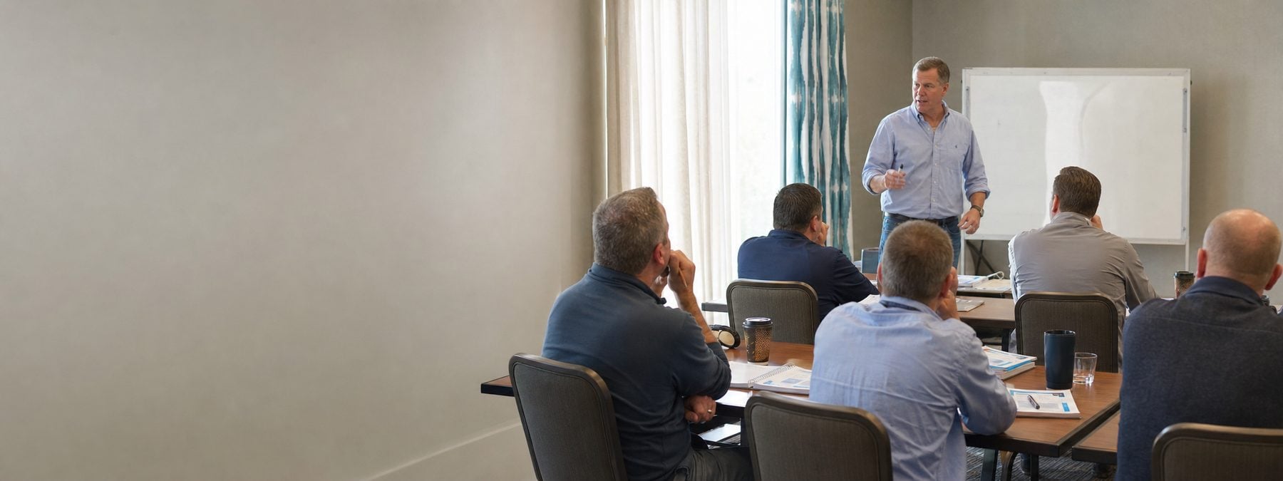 A sales leader guiding a small group through a leadership training workshop