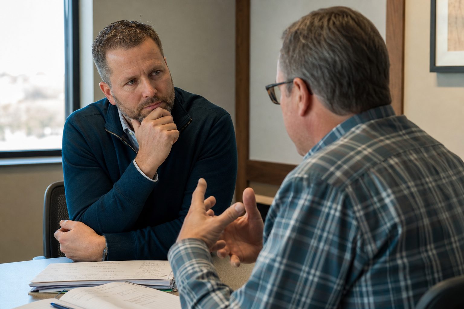 A salesperson listening closely as a buyer describes a business problem