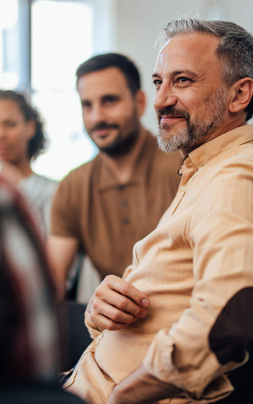 Two men seated during a private equity presentation