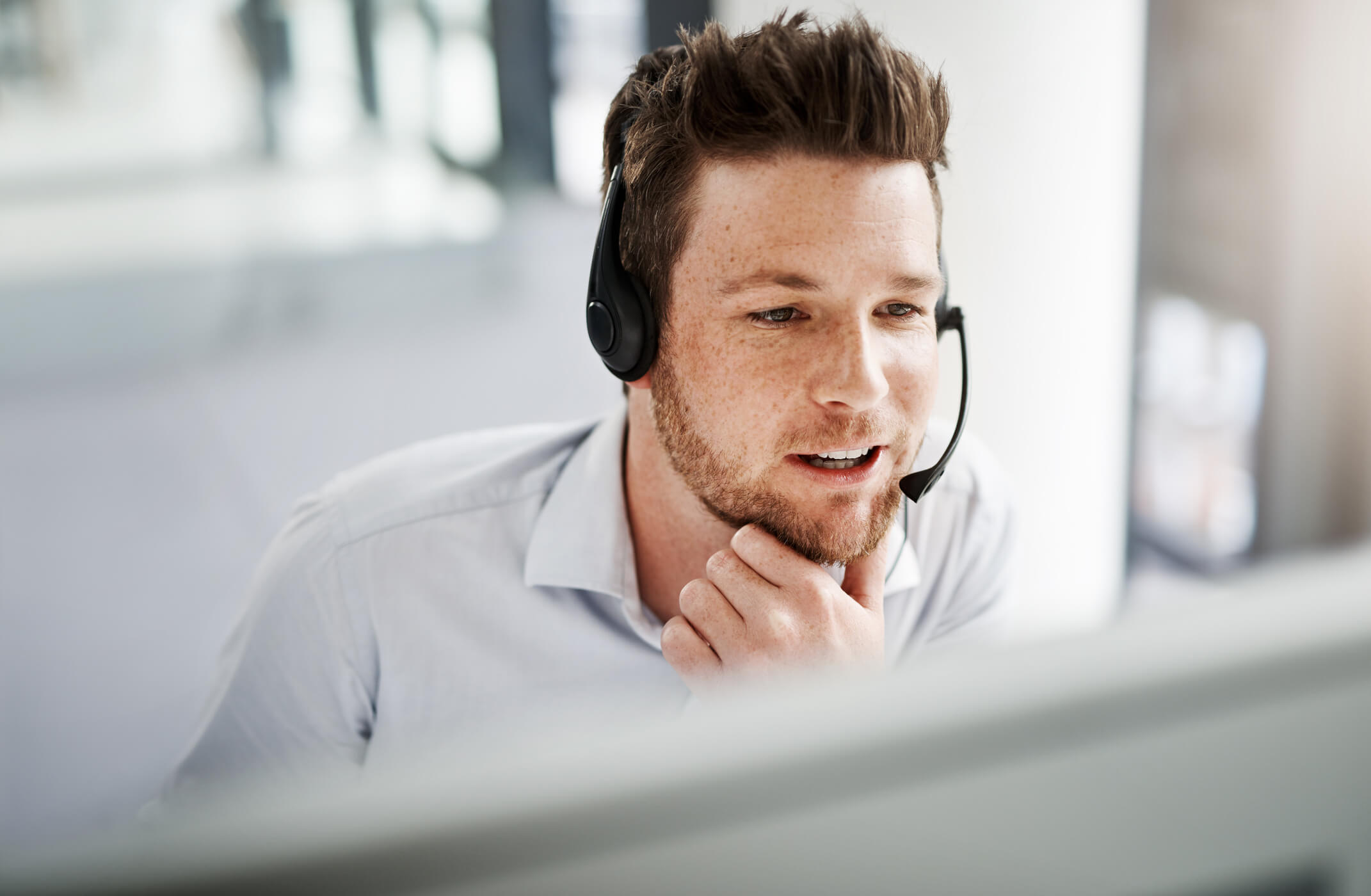 Man with headset practicing sales training with an AI solution